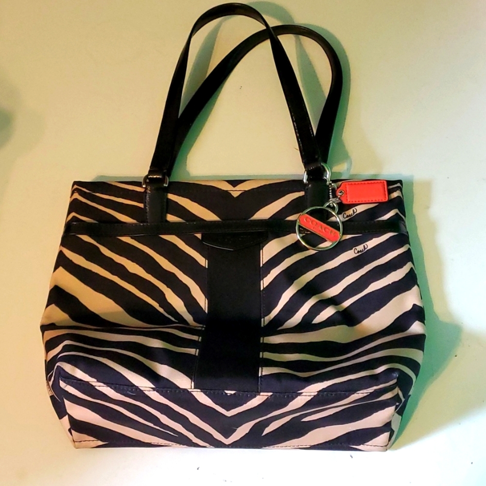 Coach women's zebra striped shoulder bag with coral color coach key ring